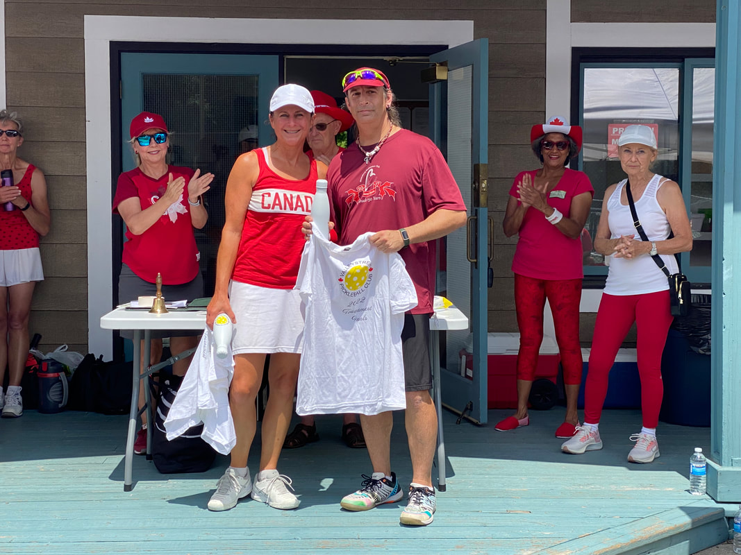 Two players holding prize shirts